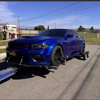 Blue Dodge Charger on wheel dollies