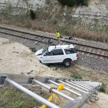 SUV recovery down an embankment beside railroad tracks